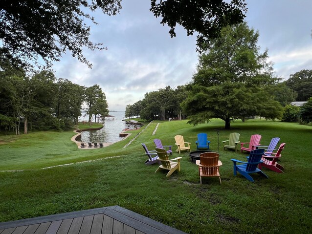 Lakefront firepit with adirondack chairs at sunset